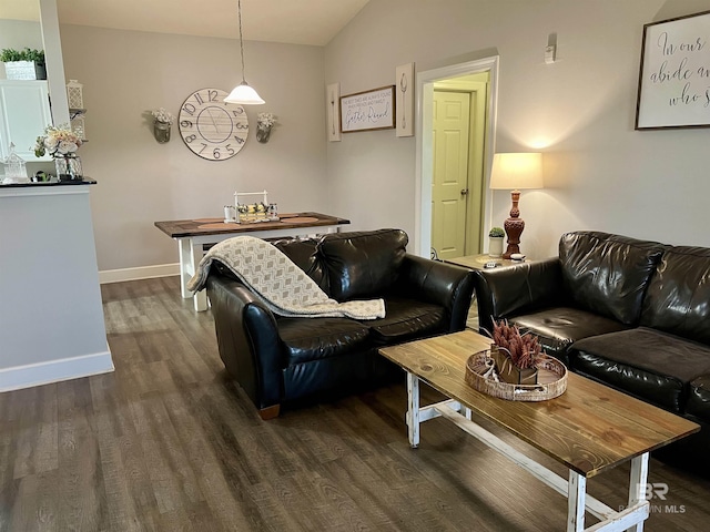 living room with dark hardwood / wood-style floors and vaulted ceiling