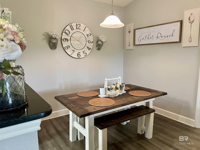 dining space with dark hardwood / wood-style floors