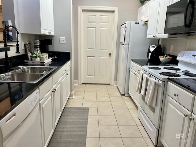 kitchen with white cabinetry, white appliances, sink, and light tile patterned floors