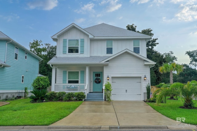 view of front of home featuring a garage, covered porch, and a front lawn