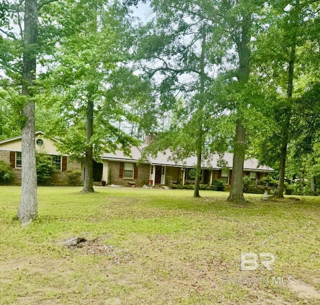 view of front of house with a chimney and a front yard