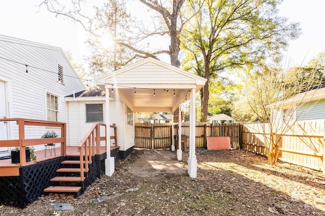 rear view of house featuring a fenced backyard and a wooden deck