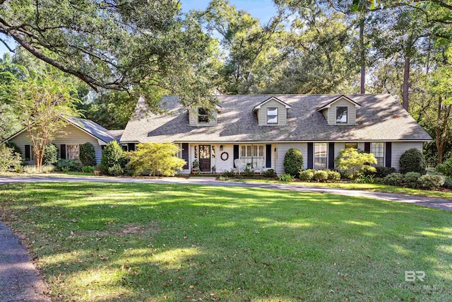 cape cod house with a front lawn