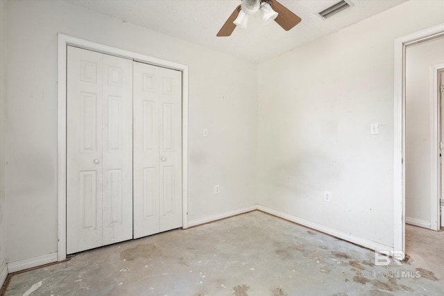 unfurnished bedroom with baseboards, visible vents, unfinished concrete floors, and a closet