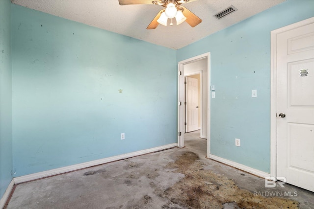 unfurnished bedroom featuring baseboards, a ceiling fan, concrete floors, and visible vents