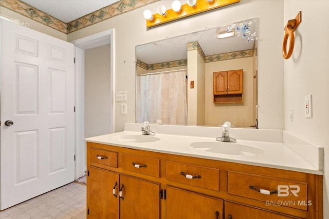 bathroom with a sink, tile patterned floors, and double vanity