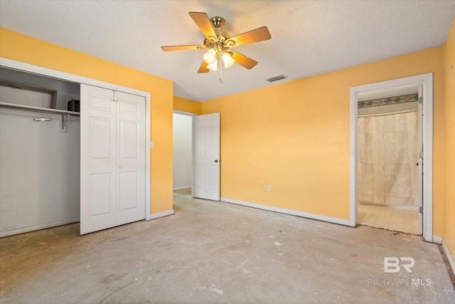 unfurnished bedroom featuring baseboards, a closet, concrete floors, and visible vents