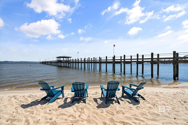 dock area with a beach view and a water view