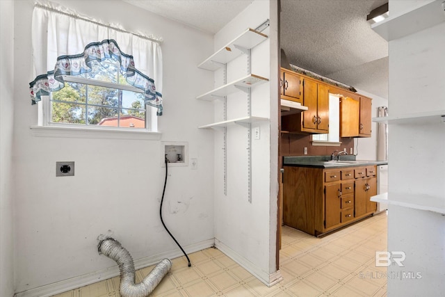 laundry room featuring light floors, hookup for an electric dryer, washer hookup, and a textured ceiling