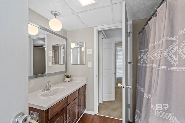 bathroom with hardwood / wood-style floors, vanity, and ceiling fan