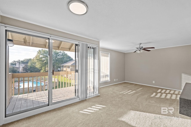 unfurnished living room featuring carpet flooring and ceiling fan