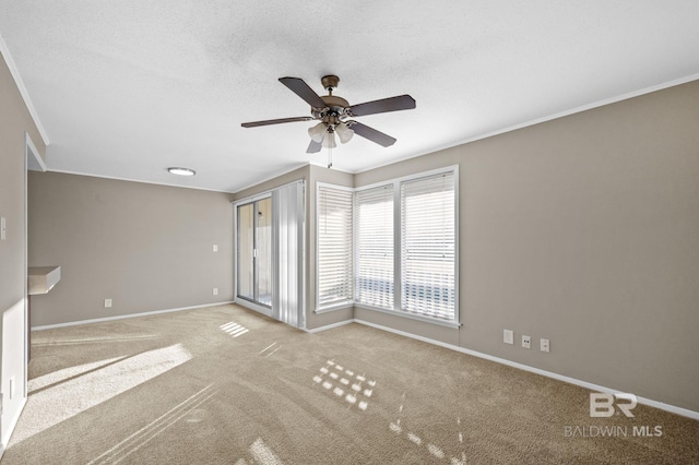 carpeted empty room featuring ceiling fan and a textured ceiling