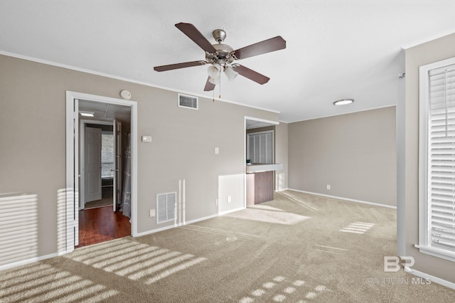 unfurnished bedroom with carpet flooring, multiple windows, ceiling fan, and ornamental molding