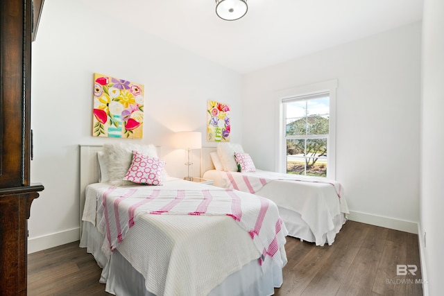 bedroom with dark wood-type flooring