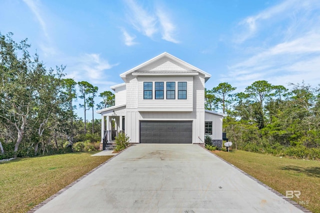 view of front of property with a front yard and a garage