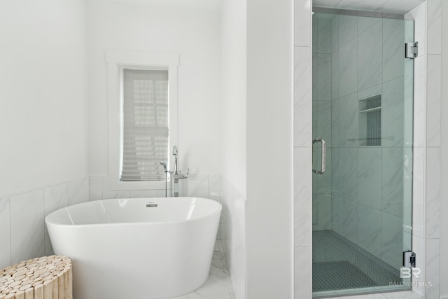 bathroom featuring independent shower and bath, radiator heating unit, and tile walls