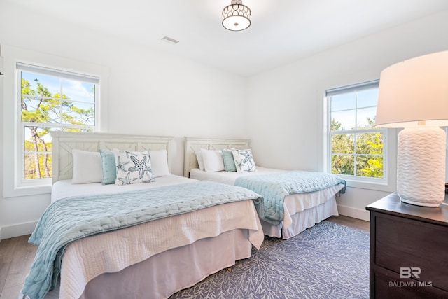 bedroom with dark wood-type flooring