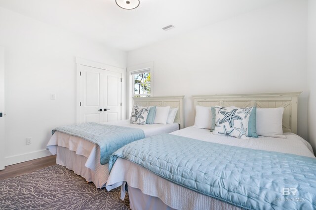 bedroom featuring dark hardwood / wood-style flooring and a closet