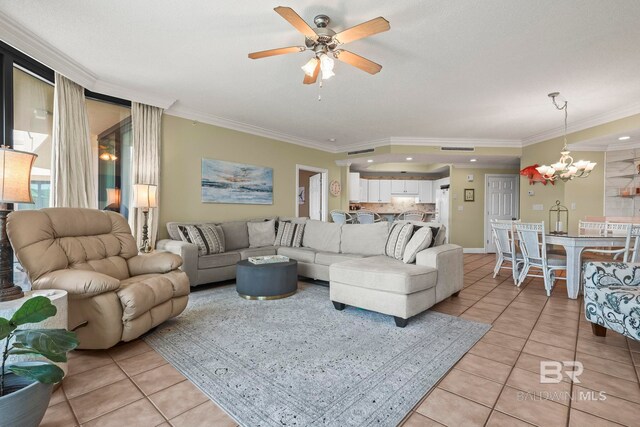 tiled living room featuring ceiling fan with notable chandelier and ornamental molding