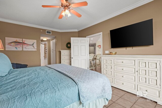 tiled bedroom featuring ornamental molding and ceiling fan