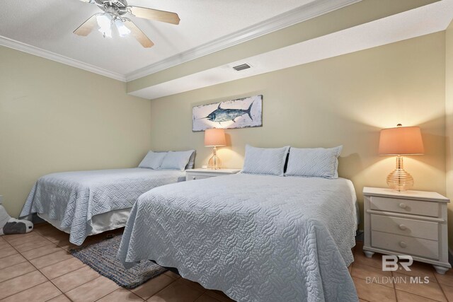 bedroom with ornamental molding, ceiling fan, and light tile patterned floors