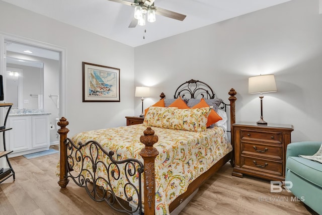 bedroom with baseboards, connected bathroom, light wood finished floors, and ceiling fan