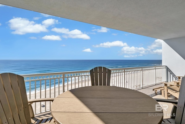 balcony featuring a water view and a beach view