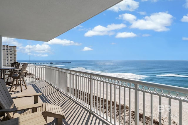 balcony with a beach view and a water view