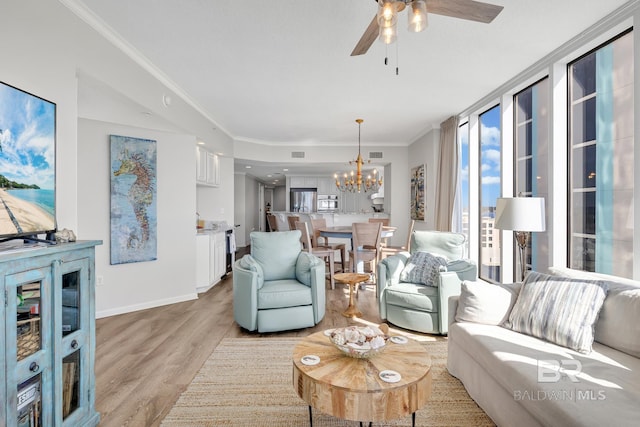 living room with baseboards, visible vents, crown molding, light wood-type flooring, and ceiling fan with notable chandelier