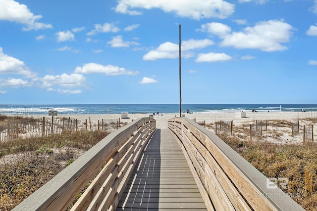 view of home's community featuring a water view and a view of the beach