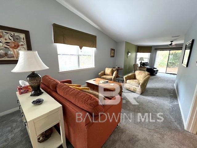 carpeted living room featuring lofted ceiling