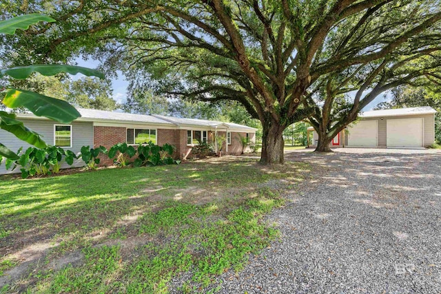 ranch-style home with a garage and an outbuilding