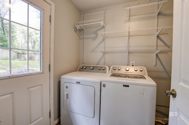 laundry room featuring independent washer and dryer and a textured ceiling