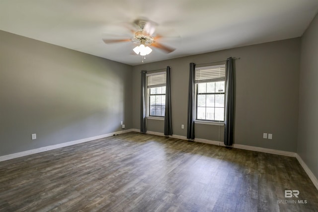 unfurnished room featuring ceiling fan and dark hardwood / wood-style flooring