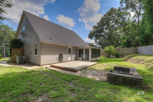 back of property with cooling unit and a yard