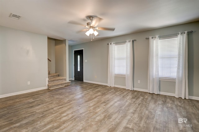 empty room with ceiling fan and wood-type flooring