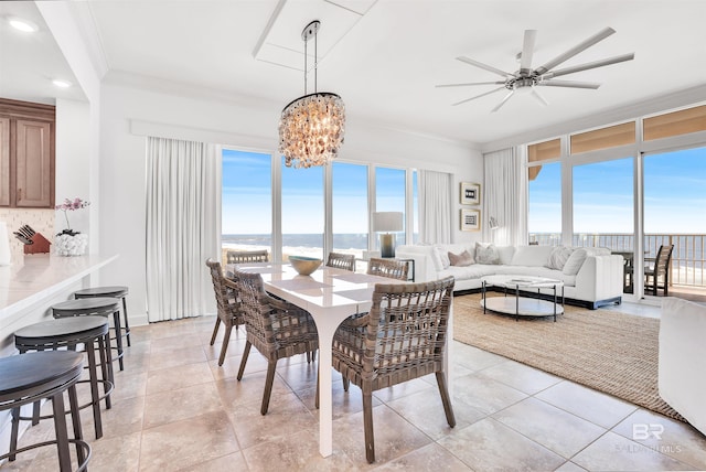 26688 Perdido Beach Blvd Unit 505, Orange Beach, AL 36561 - dining room with ornamental molding, a wealth of natural light, light tile patterned floors, and ceiling fan with notable chandelier