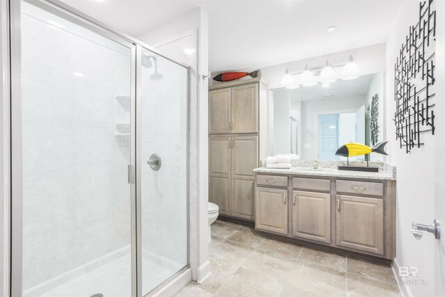 26688 Perdido Beach Blvd Unit 505, Orange Beach, AL 36561 - bathroom with toilet, a stall shower, vanity, and baseboards