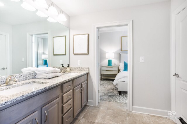 26688 Perdido Beach Blvd Unit 505, Orange Beach, AL 36561 - ensuite bathroom featuring double vanity, a sink, baseboards, and ensuite bath