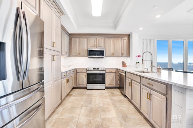 26688 Perdido Beach Blvd Unit 505, Orange Beach, AL 36561 - kitchen featuring appliances with stainless steel finishes, a peninsula, crown molding, a raised ceiling, and a sink