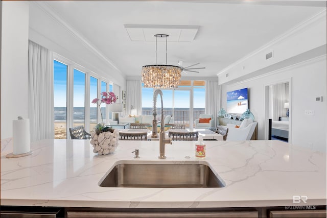 26688 Perdido Beach Blvd Unit 505, Orange Beach, AL 36561 - kitchen with open floor plan, visible vents, a sink, and ornamental molding