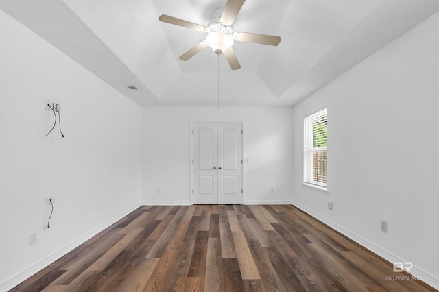 6950 Summerset Dr, Gulf Shores, AL 36542 - spare room with a tray ceiling, dark wood-style floors, ceiling fan, and baseboards