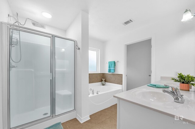 6950 Summerset Dr, Gulf Shores, AL 36542 - full bath with a stall shower, a garden tub, tile patterned flooring, and vanity