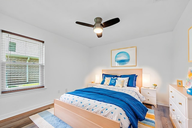 6950 Summerset Dr, Gulf Shores, AL 36542 - bedroom with baseboards, wood finished floors, and ceiling fan