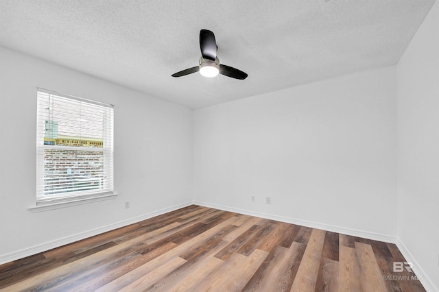 6950 Summerset Dr, Gulf Shores, AL 36542 - spare room featuring dark wood-style floors, a textured ceiling, a ceiling fan, and baseboards