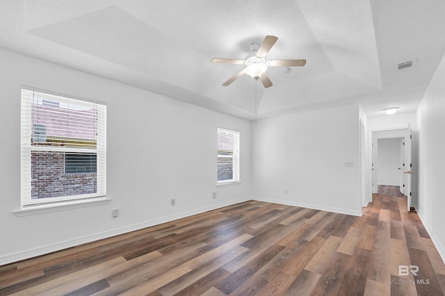 6950 Summerset Dr, Gulf Shores, AL 36542 - unfurnished room featuring a tray ceiling, wood finished floors, a ceiling fan, and baseboards