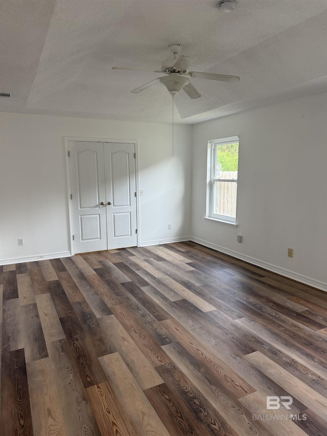 6950 Summerset Dr, Gulf Shores, AL 36542 - empty room featuring ceiling fan, dark wood-type flooring, baseboards, and a textured ceiling
