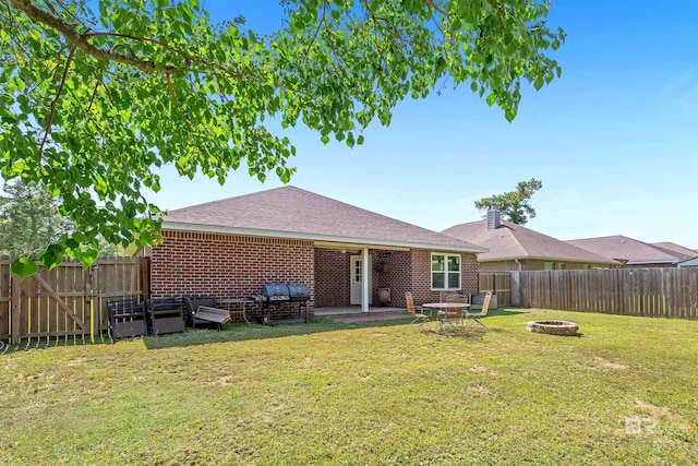 6950 Summerset Dr, Gulf Shores, AL 36542 - rear view of house featuring a fire pit, a shingled roof, a patio area, and brick siding