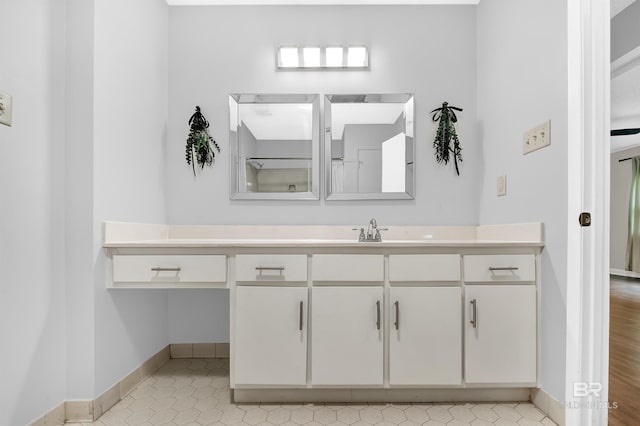 bathroom with baseboards and vanity