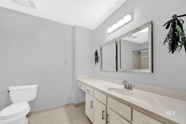 bathroom with visible vents, baseboards, toilet, vanity, and tile patterned flooring